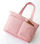 Pink tote bag with a pocket on a white background