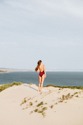 blonde woman in burgundy swimsuit